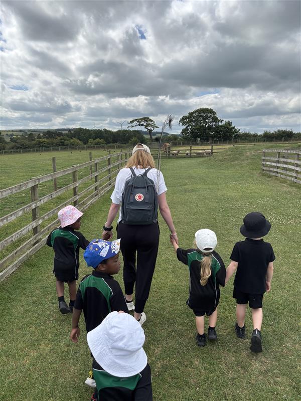 Children walking with a teacher.